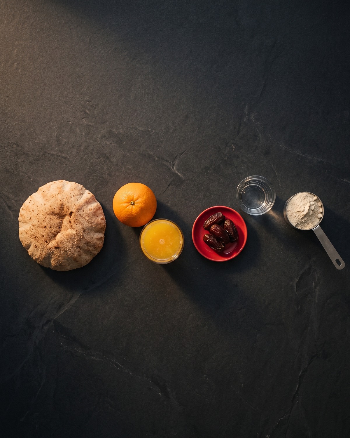 Dates, a glass of juice, baladi bread and an orange in a row: everyday foods a Ramadan diet plan measures